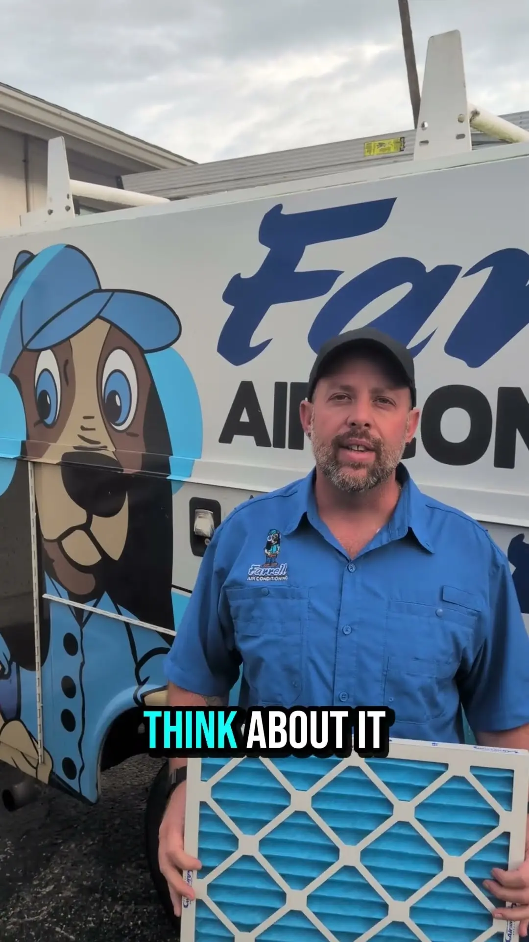 Goose from Farrell Air Conditioning holding a pleated air filter beside a Farrell service van in Port Richey